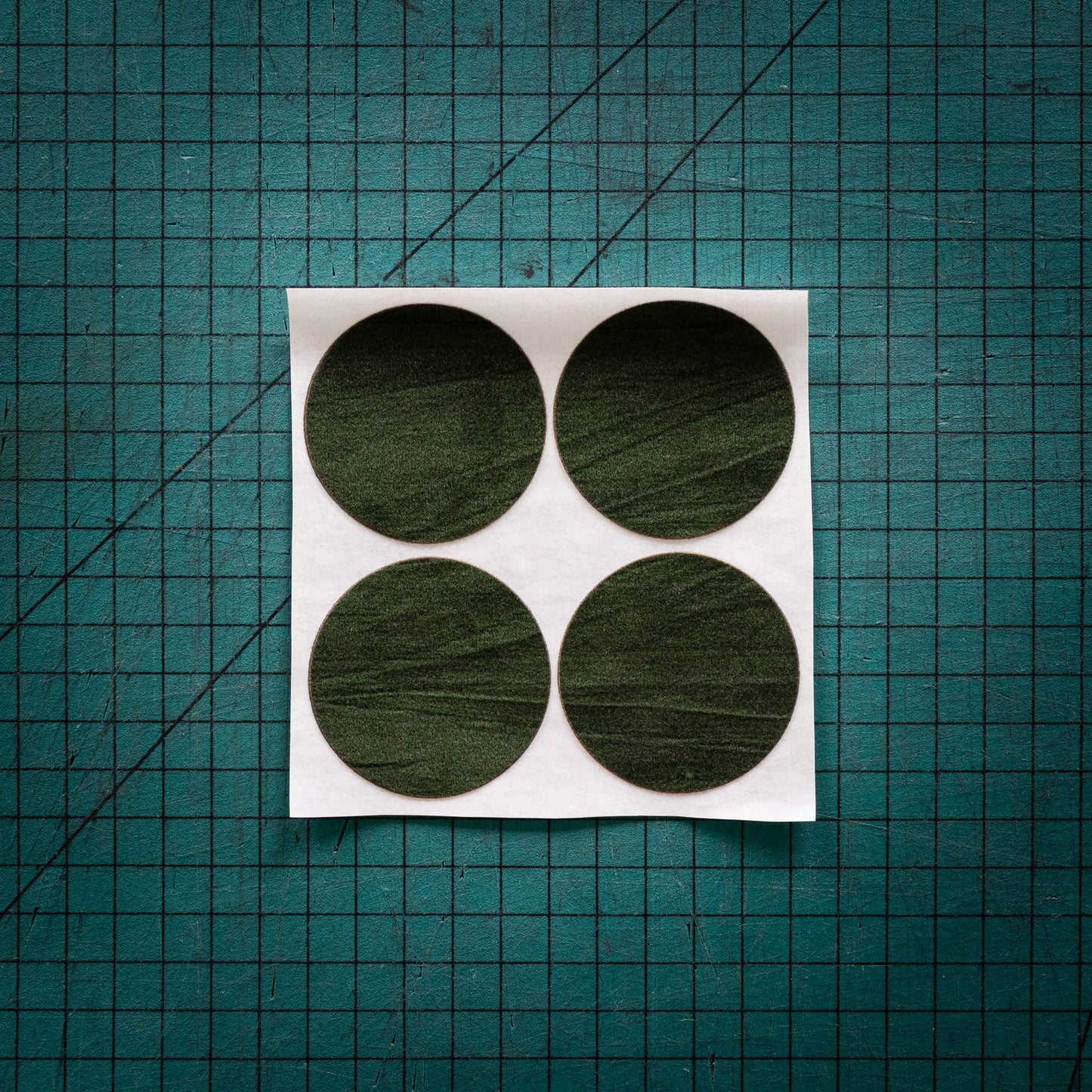 Green baize circles, sometimes known as felt, laser cut into circles