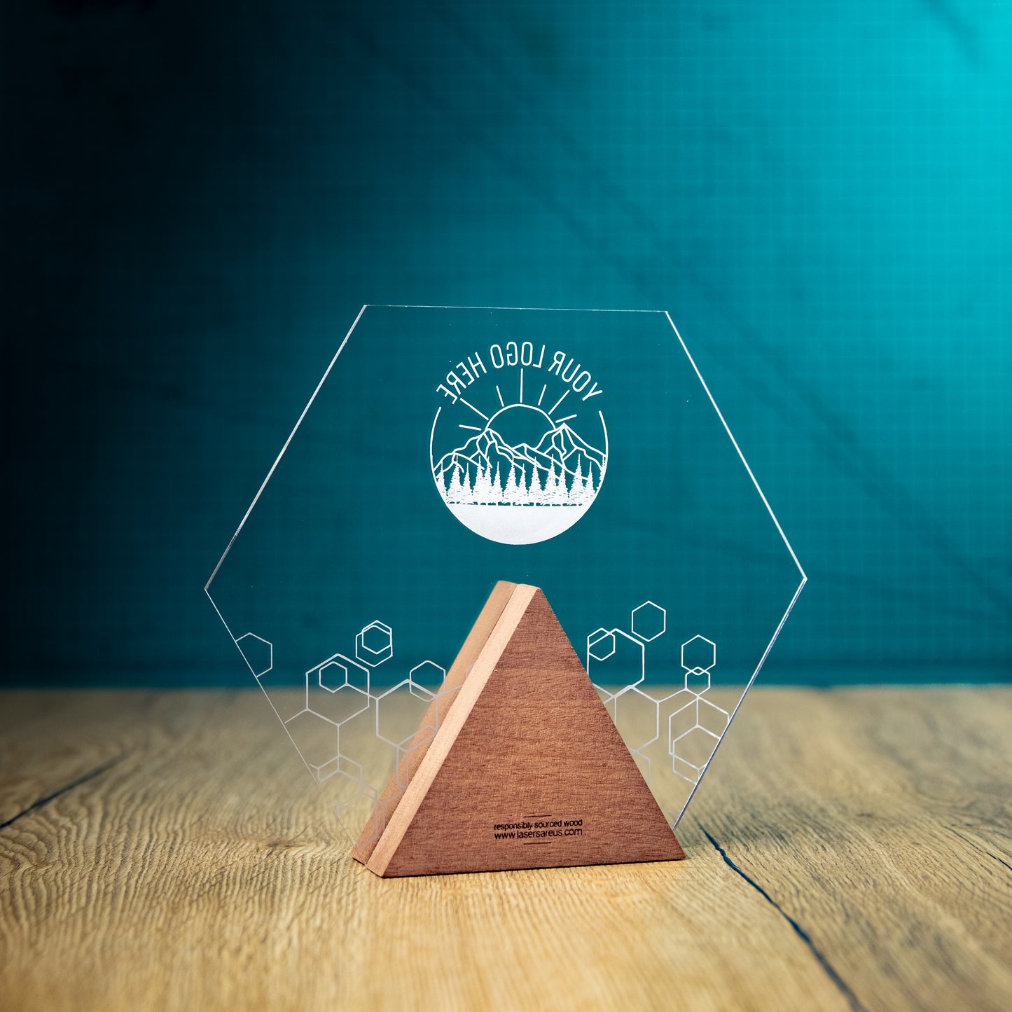 The back of the Hive Award, an Eco-friendly wooden trophy with 'responsibly sourced wood' text and www.lasersareus.com on a wooden surface.