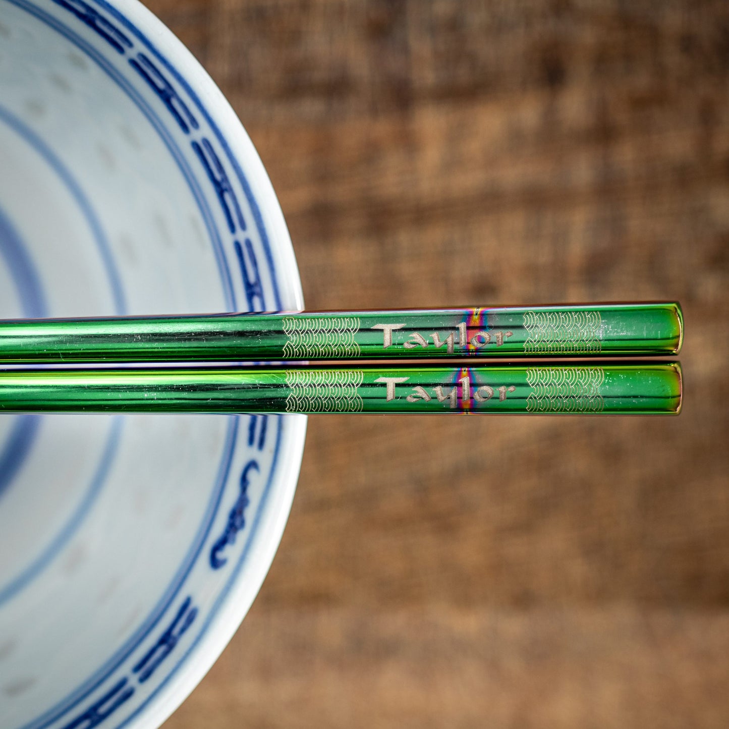 A pair of Chinese-style Metal Coloured Chopsticks - Iridencence. Each pair is personalised with either a name or a phrase.