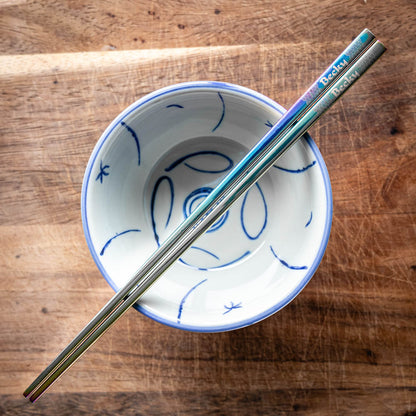 A pair of Chinese-style Metal Coloured Chopsticks - Iridencence. Each pair is personalised with either a name or a phrase.
