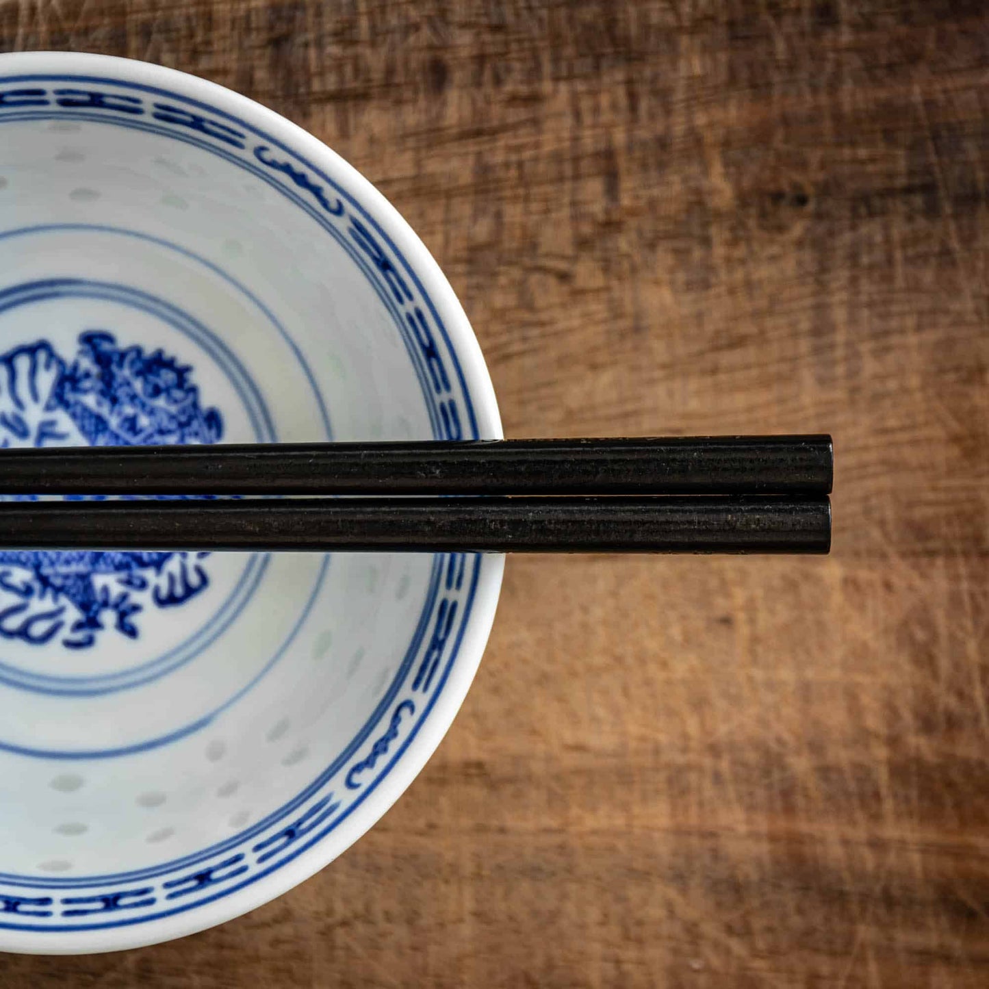 A pair of Japanese-style Chopsticks, Black wood. The pair is personalised with either a name or a phrase in English, translated into either Chinese or Japanese, and features a contemporary design at the end of the chopsticks.