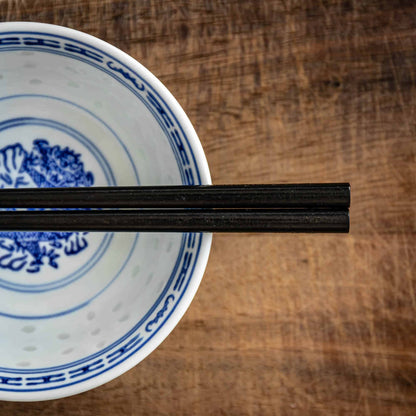 A pair of Japanese-style Chopsticks, Black wood. The pair is personalised with either a name or a phrase in English, translated into either Chinese or Japanese, and features a contemporary design at the end of the chopsticks.
