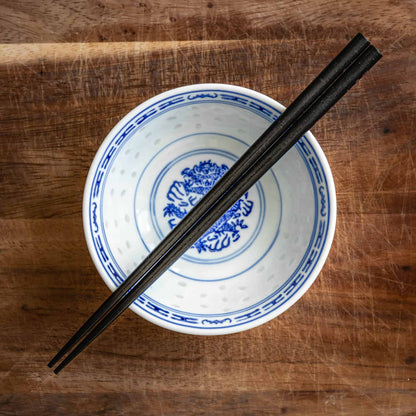 A pair of Japanese-style Chopsticks, Black wood. The pair is personalised with either a name or a phrase in English, translated into either Chinese or Japanese, and features a contemporary design at the end of the chopsticks.