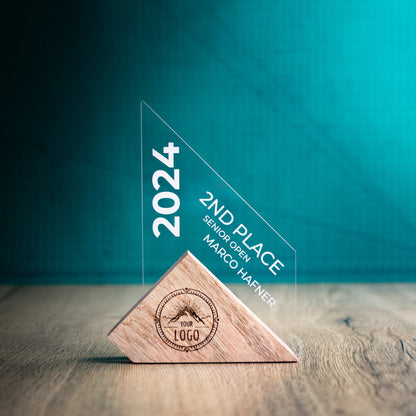A Medium Jib Award. An Eco-Friendly Wooden and Perspex Award that has a wooden base engraved with a logo and a recyclable clear Perspex triangular shape with a point on the right side of the trophy, which contains the winner and event information.