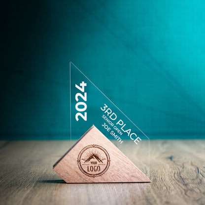 A Small Jib Award. An Eco-Friendly Wooden and Perspex Award that has a wooden base engraved with a logo and a recyclable clear Perspex triangular shape with a point on the right side of the trophy, which contains the winner and event information.