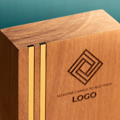 Close-up of the top-left corner of a Kingdom wooden trophy, showing two narrow gold metallic inlays running vertically through the wood and sitting flush with the front surface and top edge.