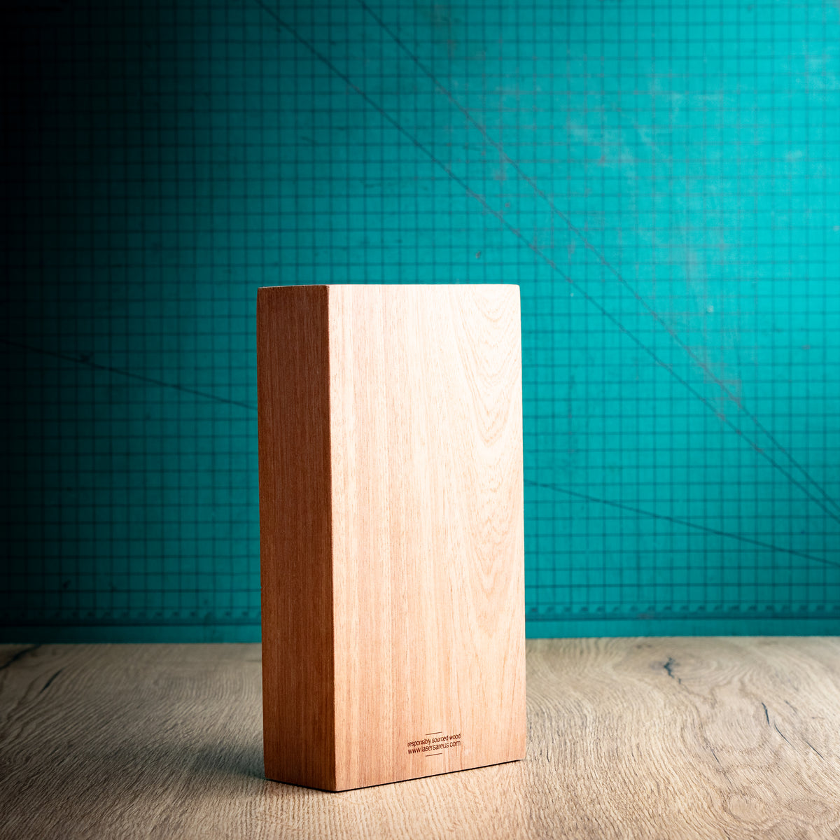 Rear three-quarter view of the large Kingdom trophy showing its tall rectangular wooden block construction, substantial depth and uninterrupted natural wood grain across the back and side.