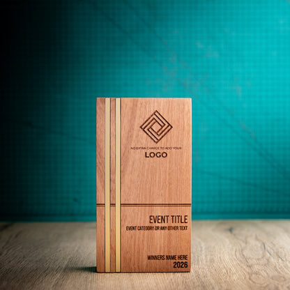 Front view of the large Kingdom wooden trophy, a tall rectangular block with two parallel gold metallic inlays running the full height near the left edge and engraved logo, event, winner and year details.
