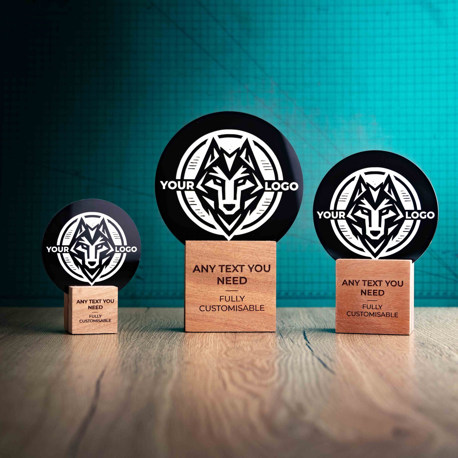 Three Legacy trophies with custom text and logos, on eco-friendly wooden bases, with a black Perspex circle mounted on top, featuring fully customisable areas for text and logos.