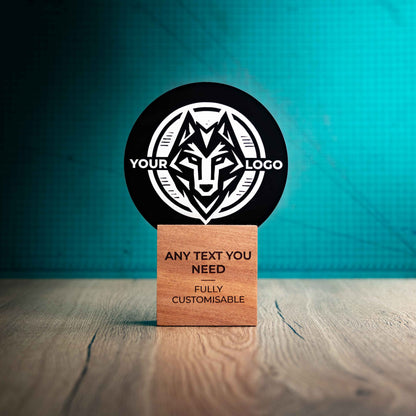 A large Legacy trophy with custom text and logos, on an eco-friendly wooden base, with a black Perspex circle mounted on top, featuring fully customisable areas for text and logos.