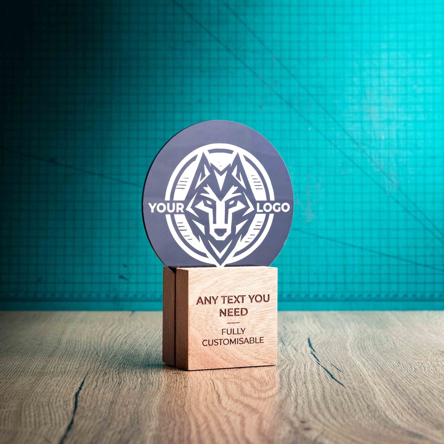 A side view of a medium Legacy trophy with custom text and logos, on an eco-friendly wooden base, with a black Perspex circle mounted on top, featuring fully customisable areas for text and logos.