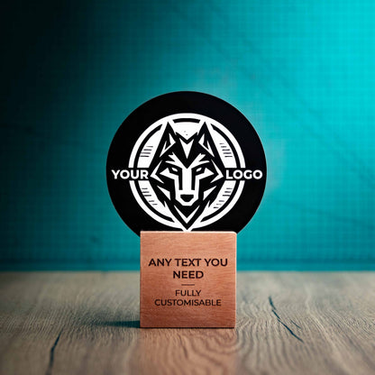 A medium Legacy trophy with custom text and logos, on an eco-friendly wooden base, with a black Perspex circle mounted on top, featuring fully customisable areas for text and logos.