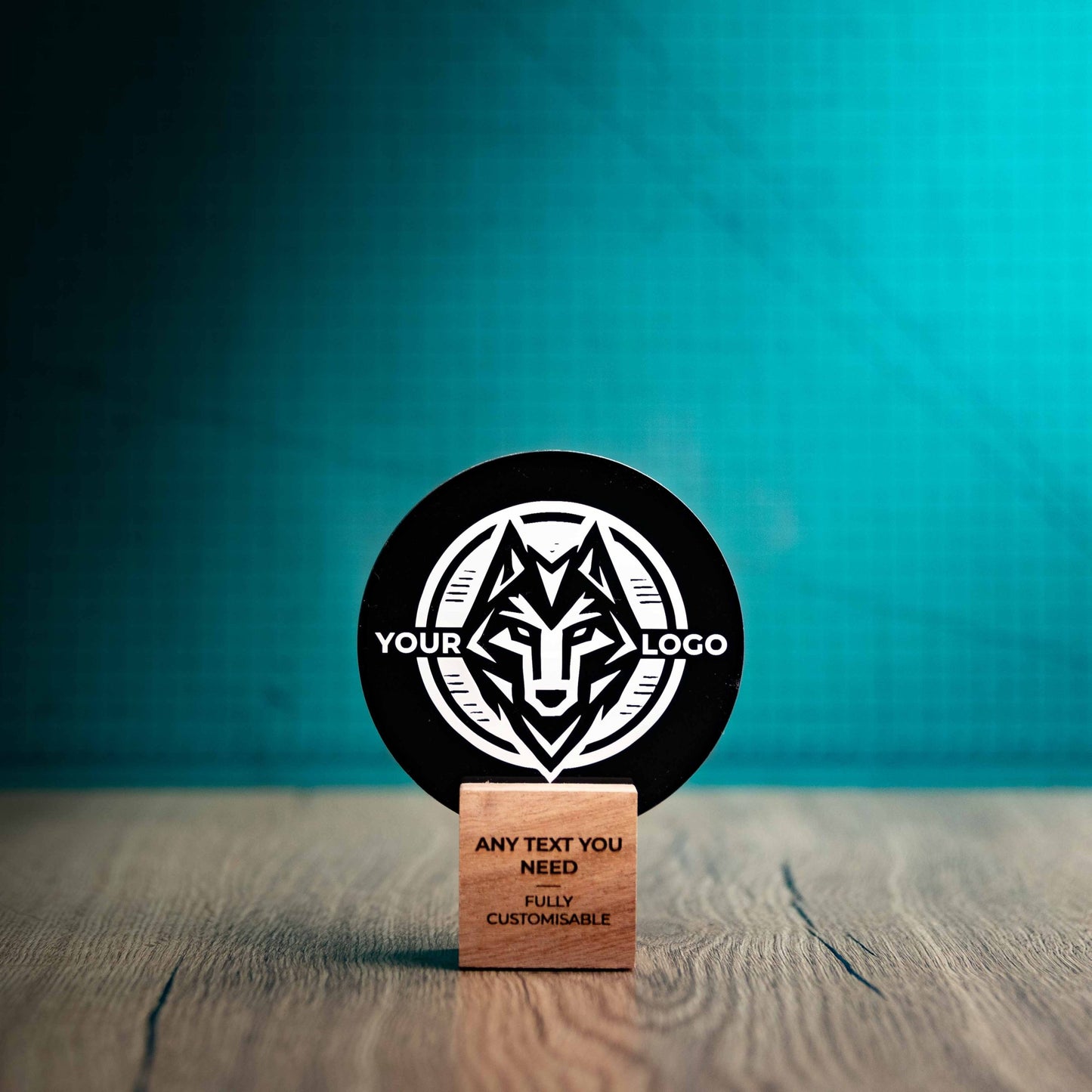 A small Legacy trophy with custom text and logos, on an eco-friendly wooden base, with a black Perspex circle mounted on top, featuring fully customisable areas for text and logos.