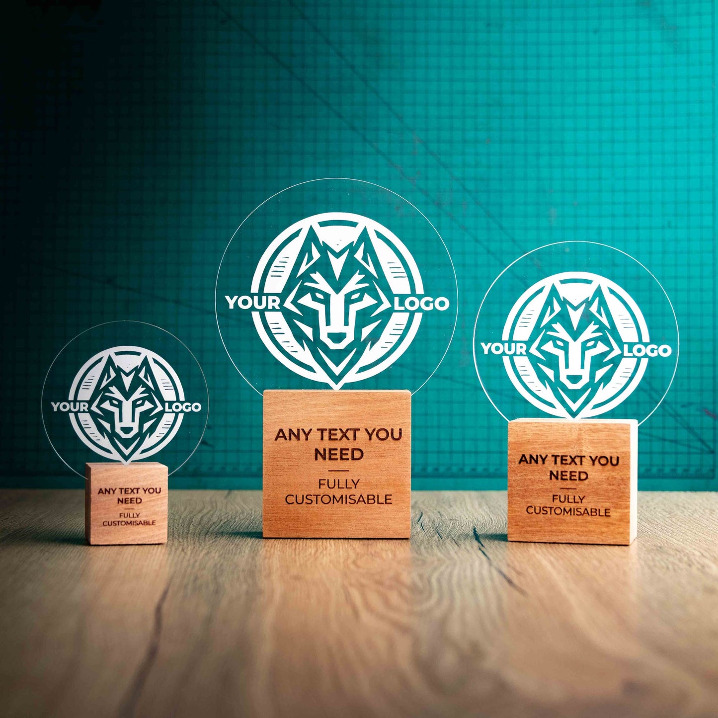 Three Legacy trophies with custom text and logos, on eco-friendly wooden bases, with a clear Perspex circle mounted on top, featuring fully customisable areas for text and logos.