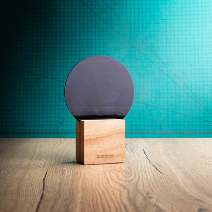 The back of the Legacy Award, an Eco-friendly wooden trophy with 'responsibly sourced wood' text and www.lasersareus.com on a wooden surface.