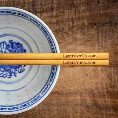 A pair of personalised dark wood Chinese Chopsticks, personalised with a Company Logo