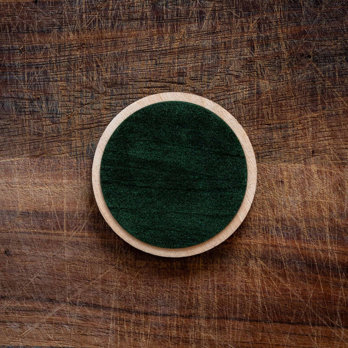 The back of a personalized wooden coaster with felt backing