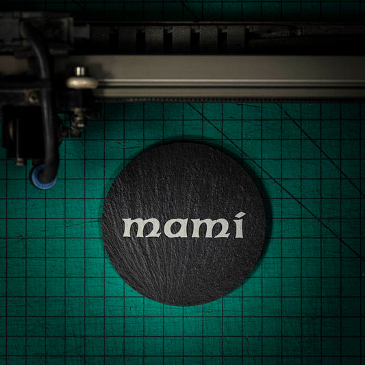 A Welsh slate coaster laser engraved with the welsh word for mummy, mami