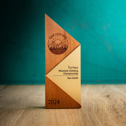 A Large Metallic Peak Trophy. An eco-friendly personalised wooden trophy with a gold acrylic accent. A Triangular wooden trophy laser-engraved with a logo and trophy personalisation.