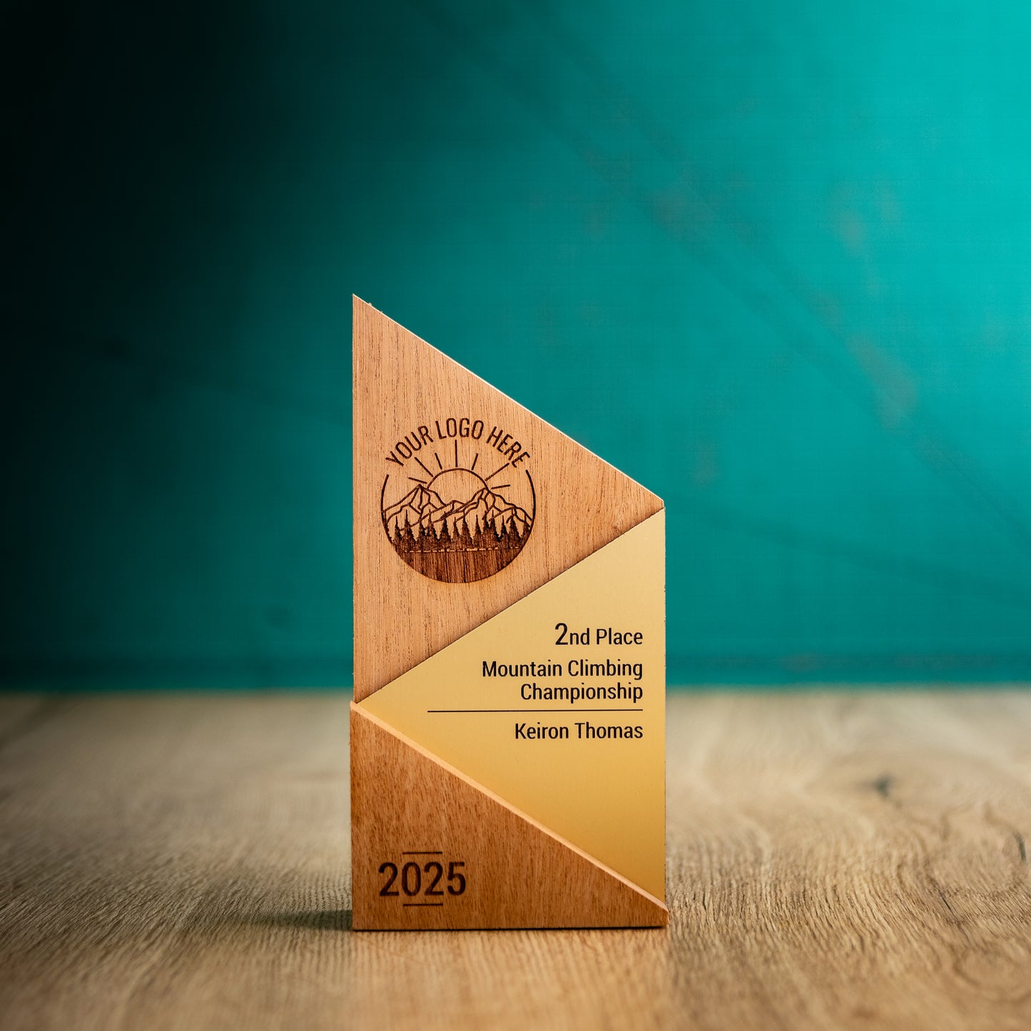 A Medium Metallic Peak Trophy. An eco-friendly personalised wooden trophy with a gold acrylic accent. A Triangular wooden trophy laser-engraved with a logo and trophy personalisation.
