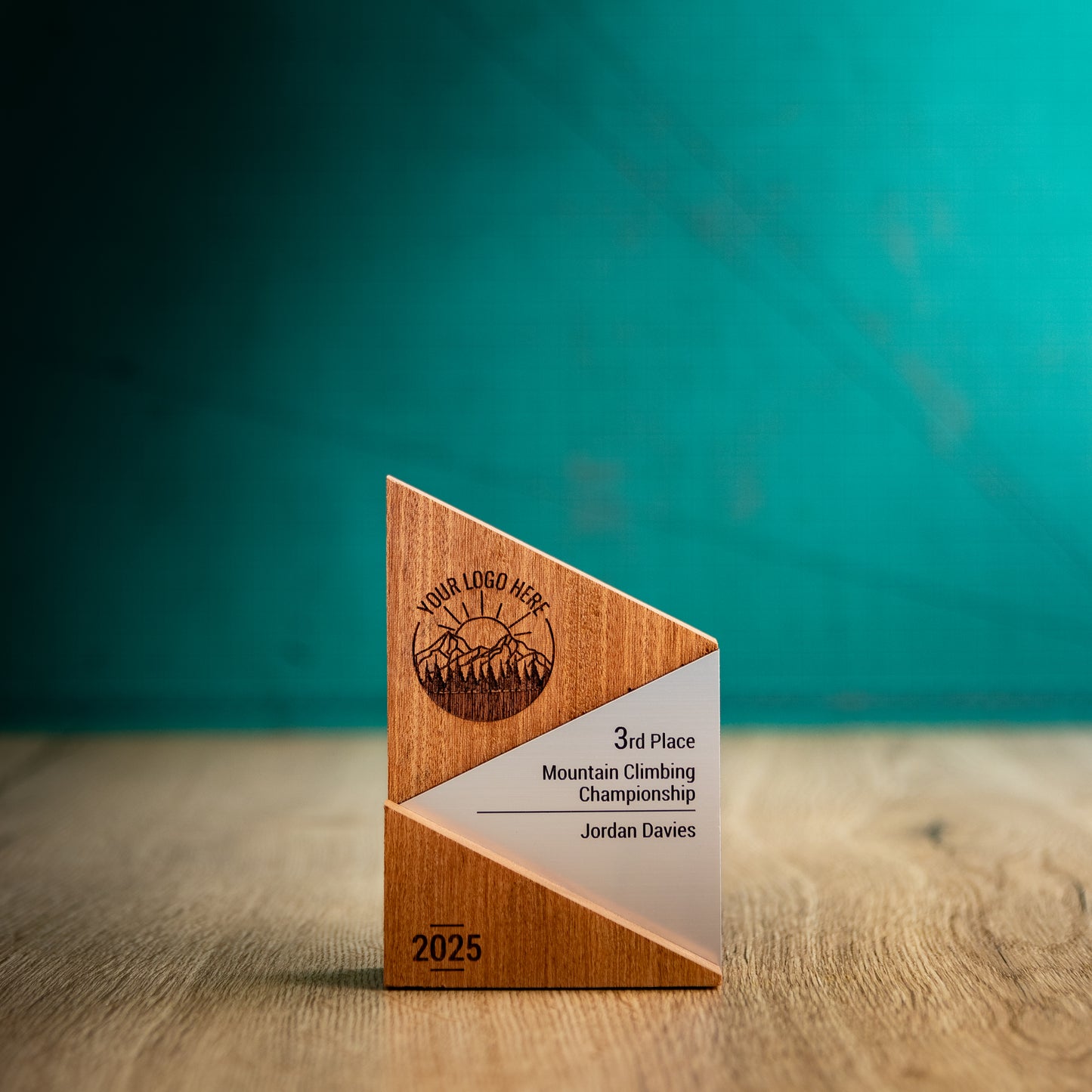 A Small Metallic Peak Trophy. An eco-friendly personalised wooden trophy with a silver acrylic accent. A Triangular wooden trophy laser-engraved with a logo and trophy personalisation.