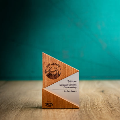 A Small Metallic Peak Trophy. An eco-friendly personalised wooden trophy with a silver acrylic accent. A Triangular wooden trophy laser-engraved with a logo and trophy personalisation.