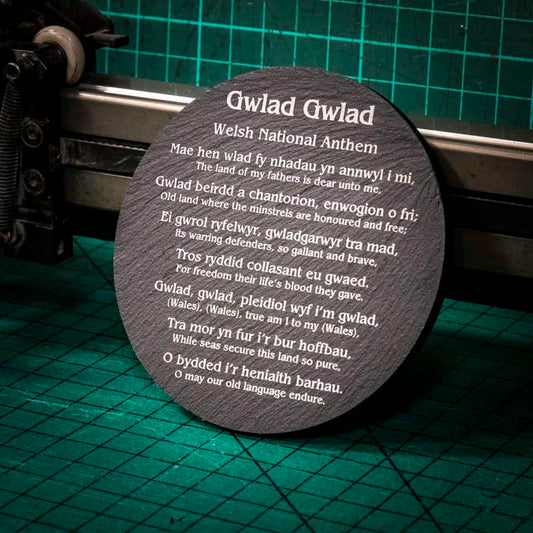A laser engraved Welsh slate coaster with words of the welsh national anthem in English and Welsh