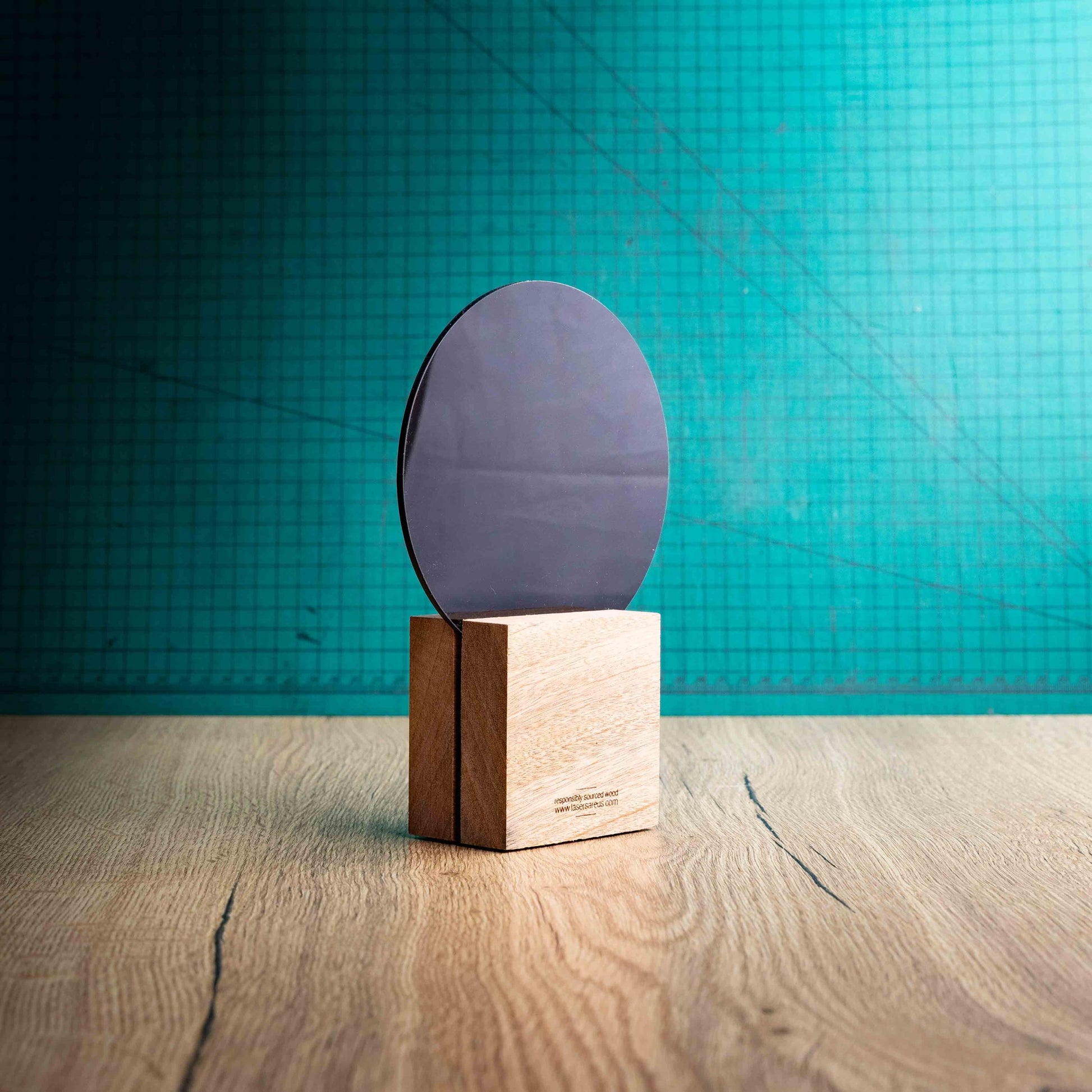 A back view of a medium Netball trophy with custom text and logos, on an eco-friendly wooden base, with a black Perspex Netball mounted on top, featuring fully customisable areas for text and logos.