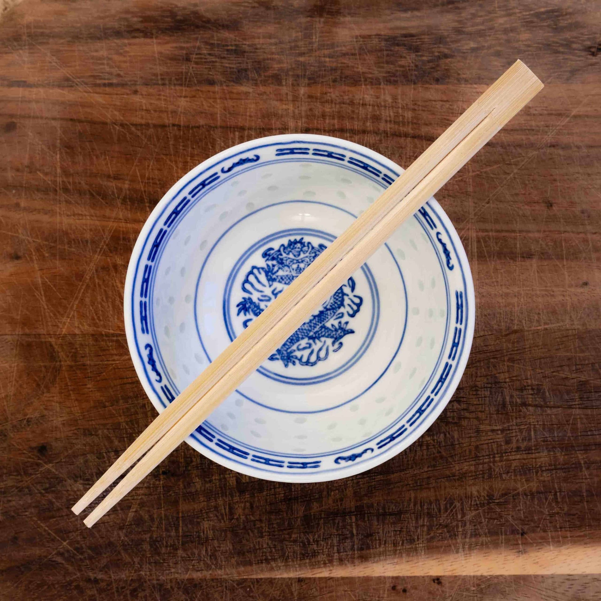A personalised pair of wooden party chopsticks laser engraved with a name in English and Chinese