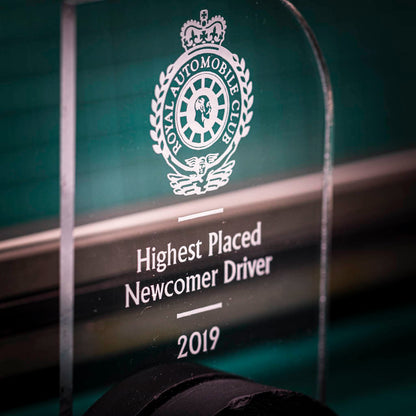 A personalised laser engraving on a perspex trophy