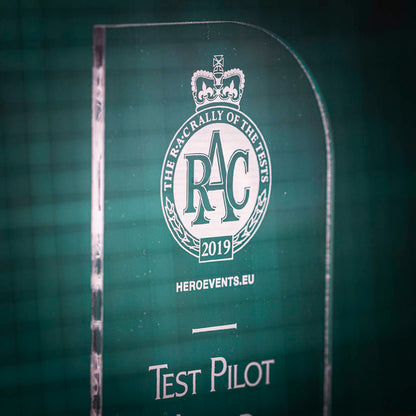A personalised laser engraving on a perspex trophy