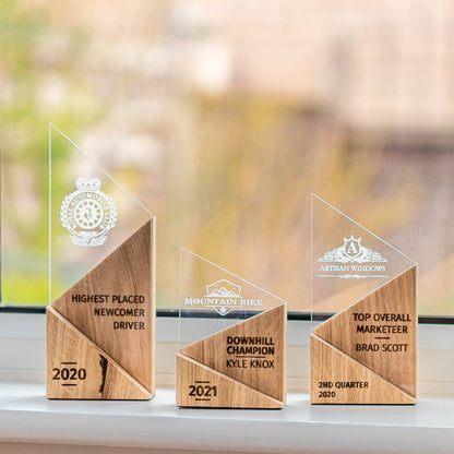 Small, medium and large personalised laser-engraved perspex trophies with an eco-friendly wooden base.