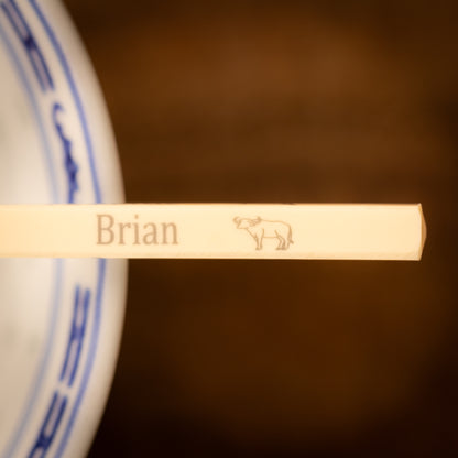 Cream coloured plastic melamine personalised chopsticks engraved with a name and Chinese Zodiac Animal, The Year of the Bull.
