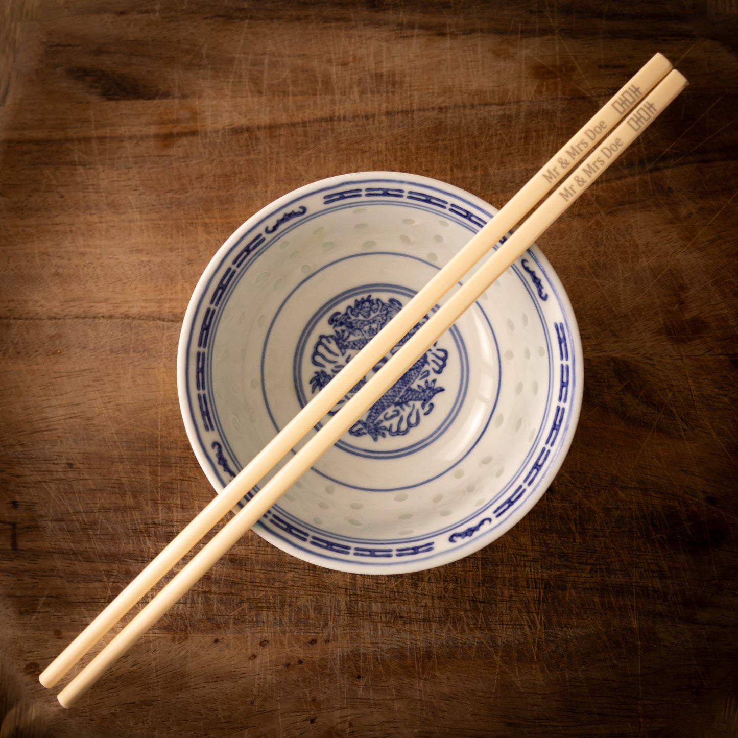 Cream coloured plastic melamine personalised chopsticks engraved for a wedding with a "Mr & Mrs Doe" and the Chinese symbol for double happiness.