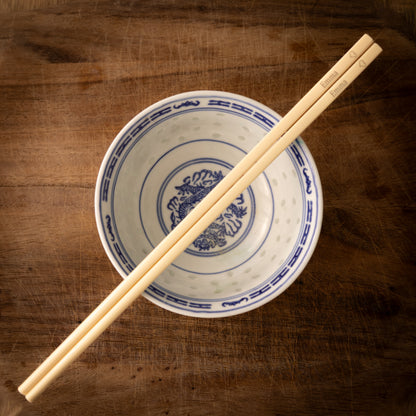 Cream coloured plastic melamine personalised chopsticks engraved with a name and a heart.