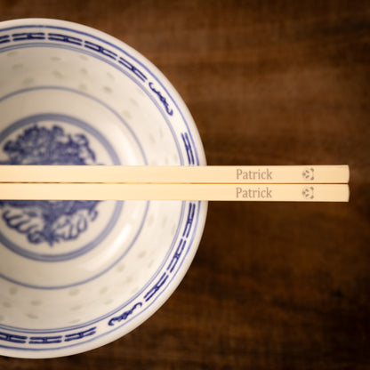 Cream coloured plastic melamine personalised chopsticks engraved with a name and a Panda face.