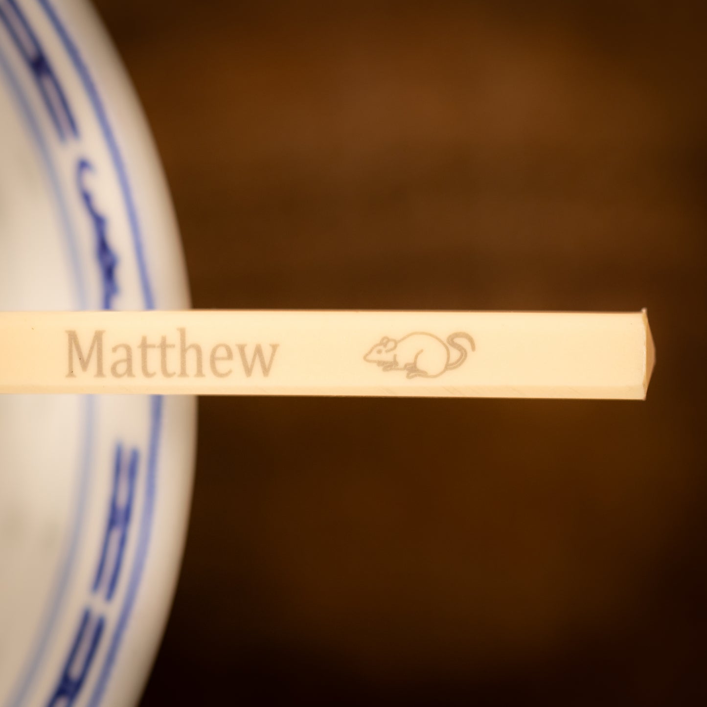 Cream coloured plastic melamine personalised chopsticks engraved with a name and Chinese Zodiac Animal, The Year of the Rat.