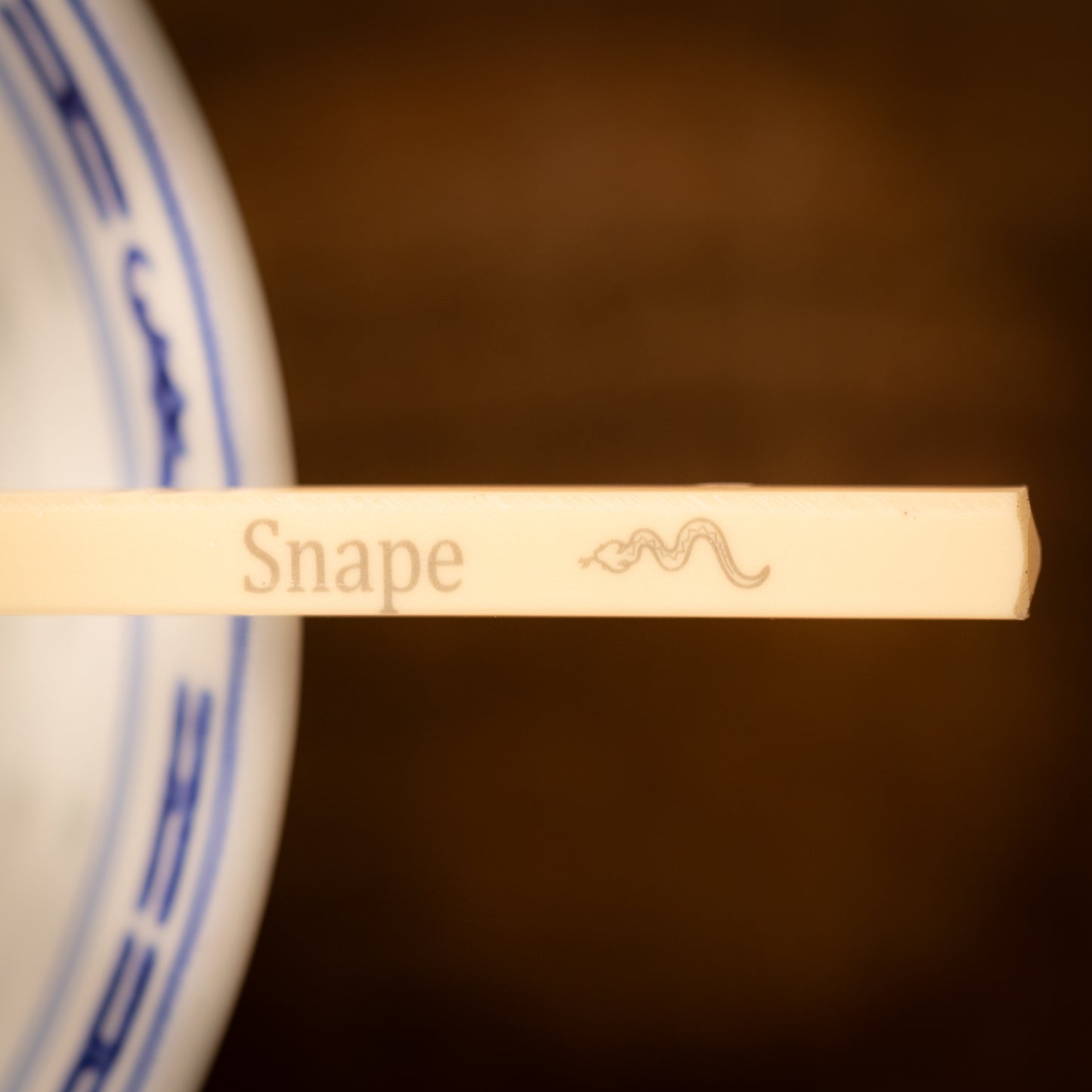 Cream coloured plastic melamine personalised chopsticks engraved with a name and Chinese Zodiac Animal, The Year of the Snake.