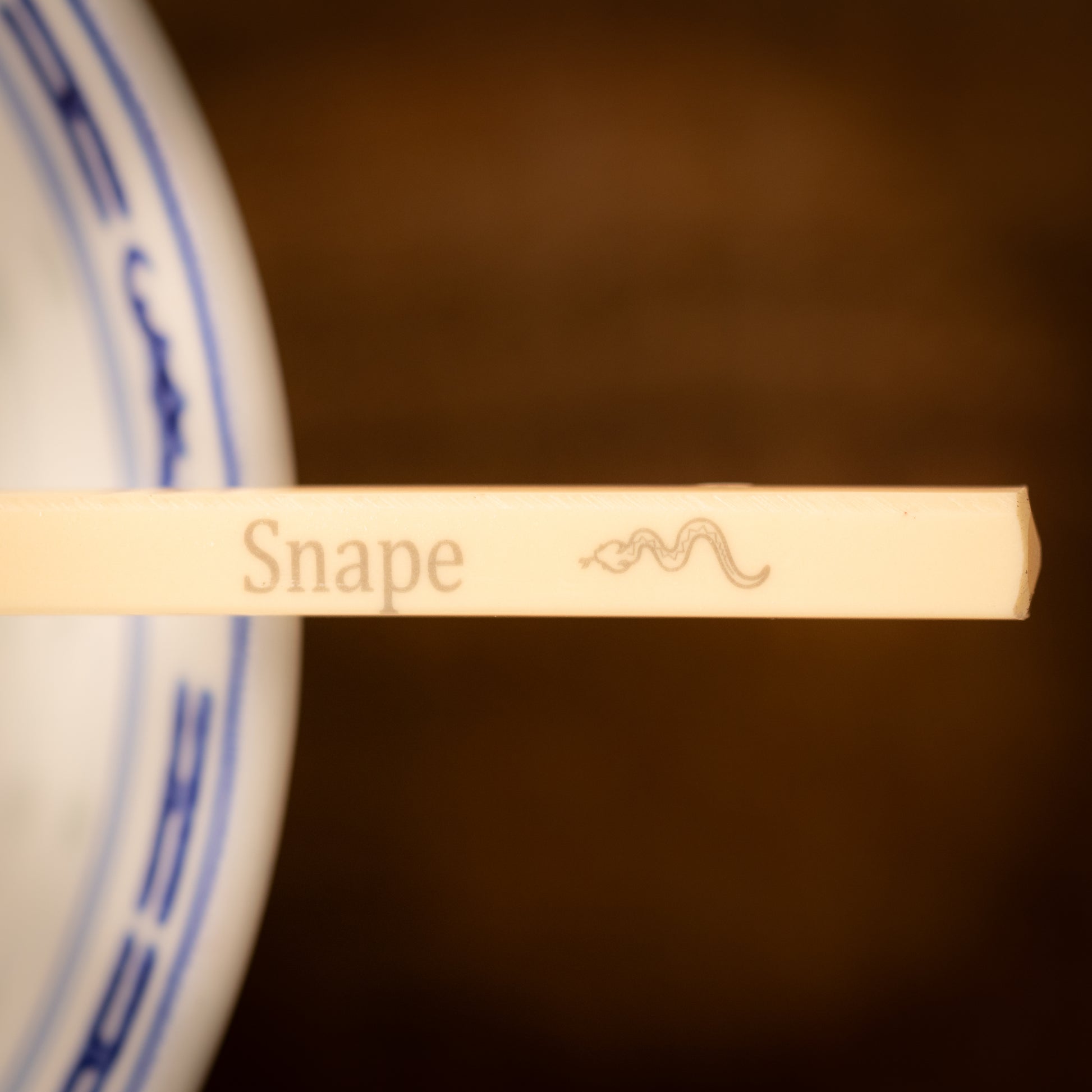 Cream coloured plastic melamine personalised chopsticks engraved with a name and Chinese Zodiac Animal, The Year of the Snake.
