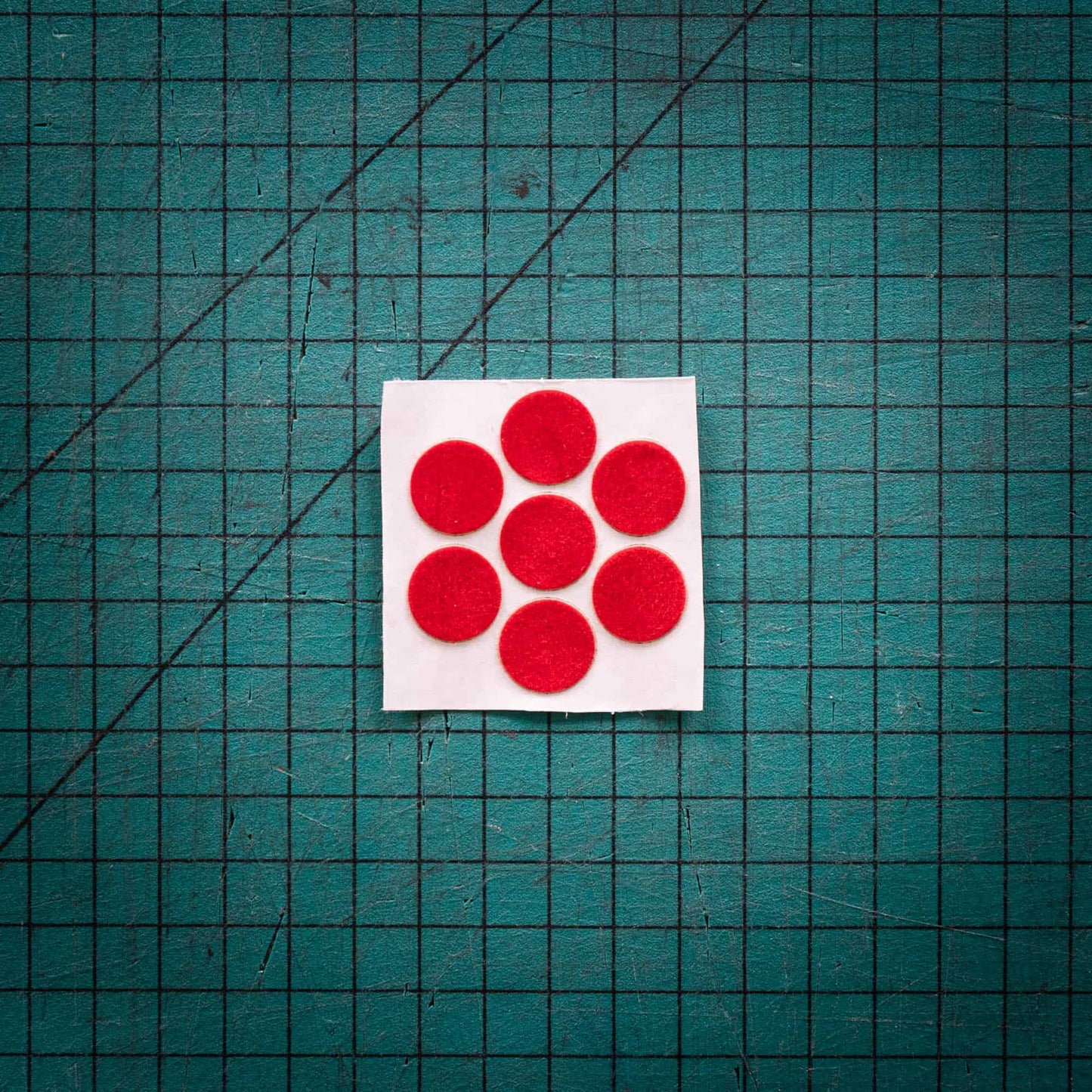 Red baize circles, sometimes known as felt, laser-cut to various sizes.