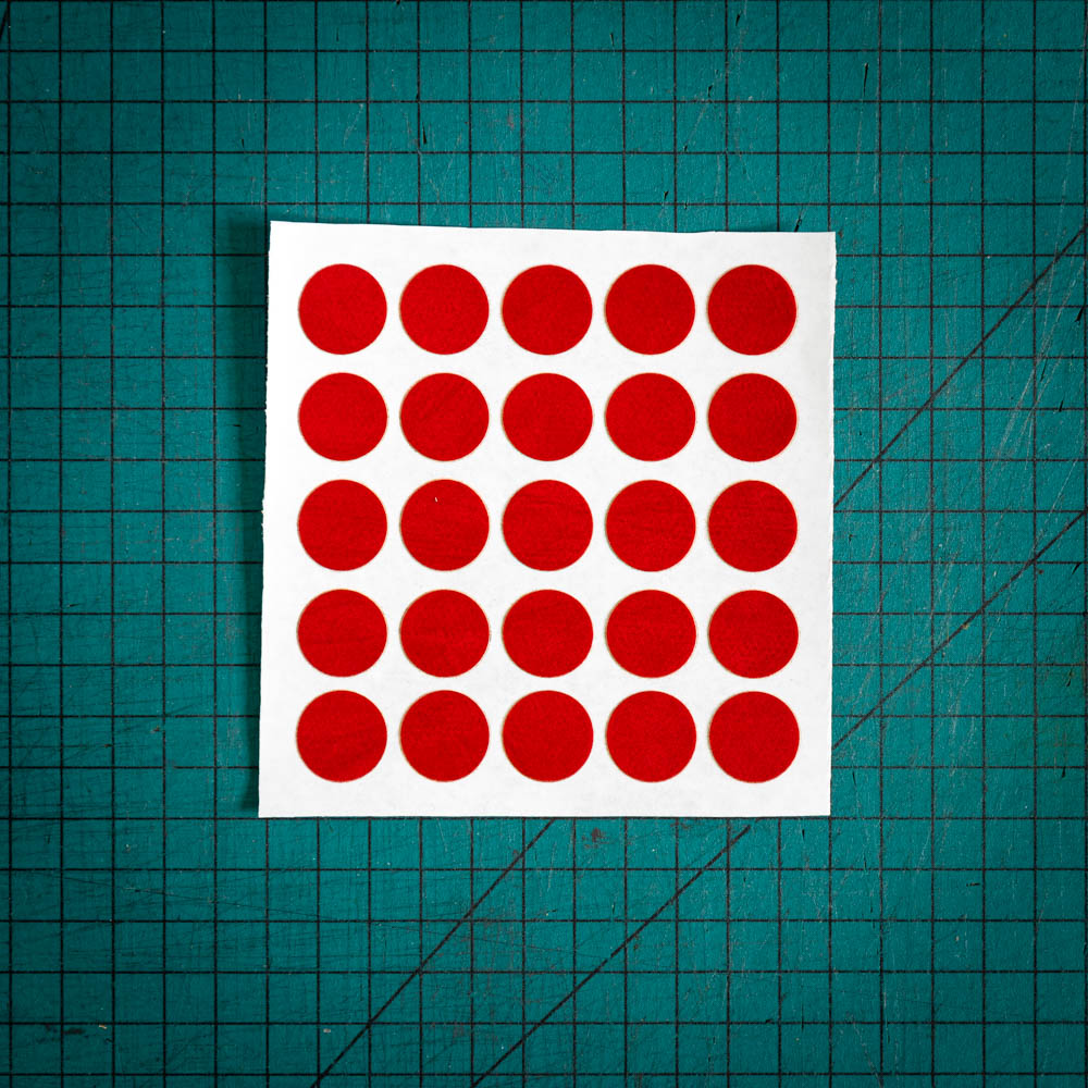 Red baize circles, sometimes known as felt, laser cut into circles