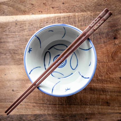 A pair of Chinese-style Metal Coloured Chopsticks - Rose Gold. Each pair is personalised with either a name or a phrase.