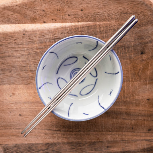 A personalised pair of rounded steel chopsticks that can be laser engraved with a name