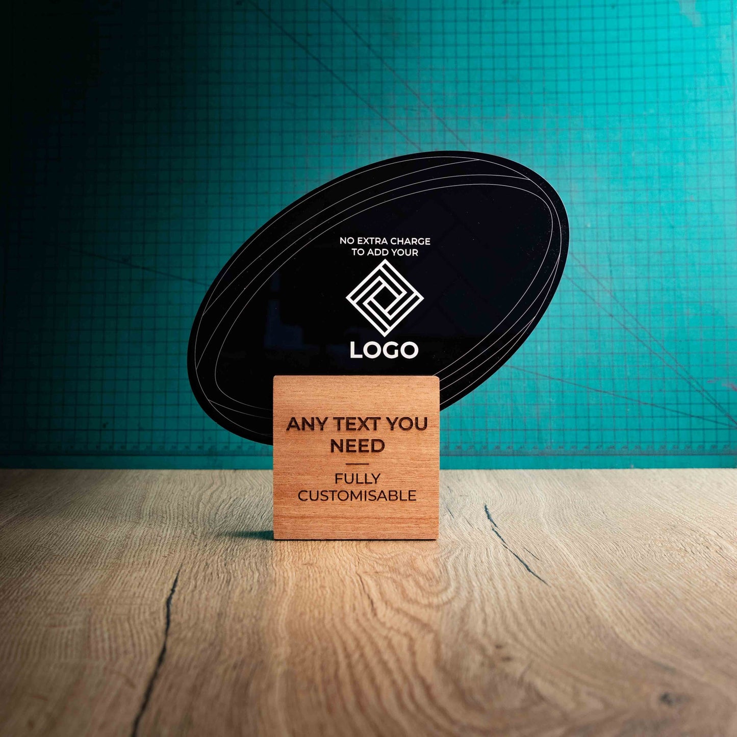 A large rugby trophy with custom text and logos, on an eco-friendly wooden base, with a black Perspex rugby ball mounted on top, featuring fully customisable areas for text and logos.