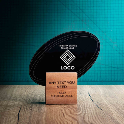 A medium rugby trophy with custom text and logos, on an eco-friendly wooden base, with a black Perspex rugby ball mounted on top, featuring fully customisable areas for text and logos.