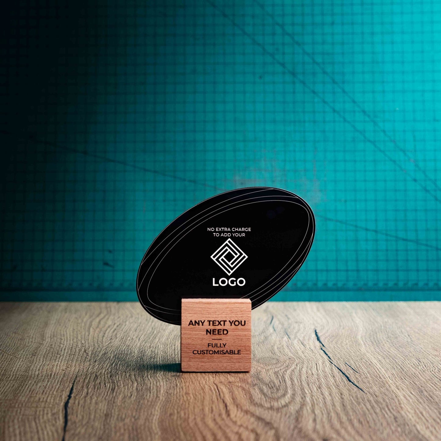 A small rugby trophy with custom text and logos, on an eco-friendly wooden base, with a black Perspex rugby ball mounted on top, featuring fully customisable areas for text and logos.