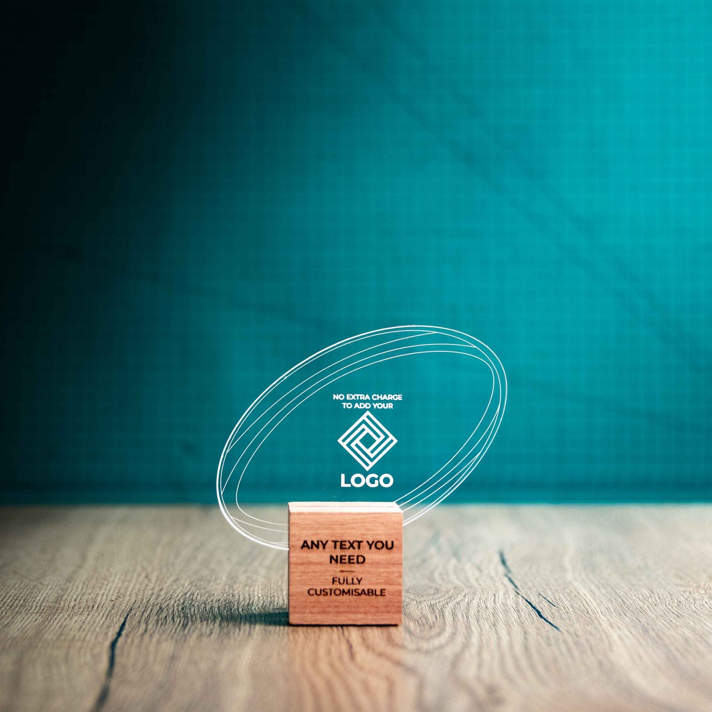 A small rugby trophy with custom text and logos, on an eco-friendly wooden base, with a clear Perspex rugby ball mounted on top, featuring fully customisable areas for text and logos.