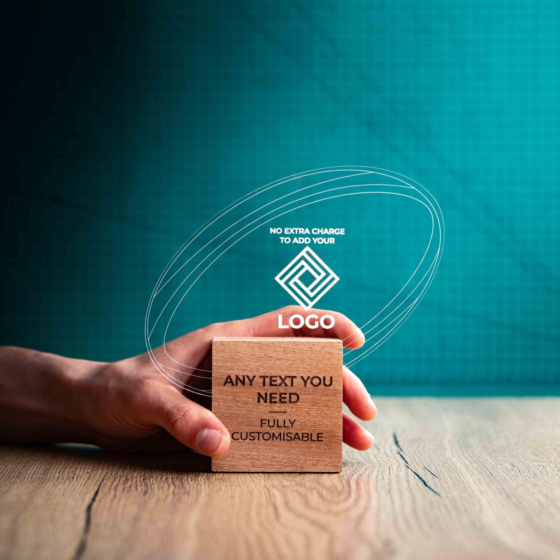 A hand holding a medium rugby award with custom text and logos, on an eco-friendly wooden base, with a clear Perspex rugby ball mounted on top, featuring fully customisable areas for text and logos.