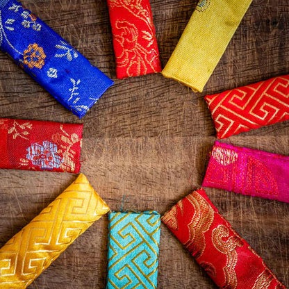 Silk chopstick pouches in a variety of colours, red, blue, navy, aqua, yellow and pink.