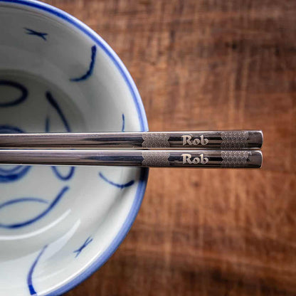 A pair of Chinese-style Metal Coloured Chopsticks - Silver. Each pair is personalised with either a name or a phrase.